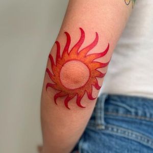 elbow colorful sun tattoo