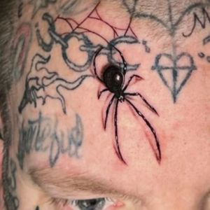 forehead spider face tattoo