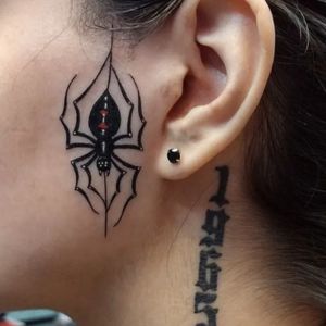 women spider face tattoo