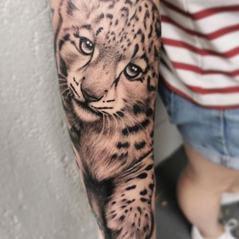 arm baby snow leopard tattoo