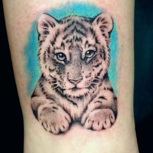 colorful baby snow leopard tattoo