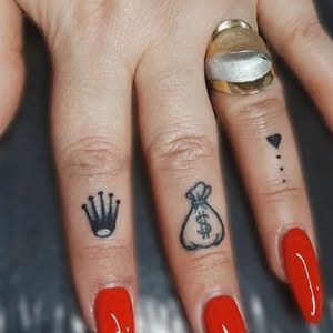 finger Rolex tattoo for women