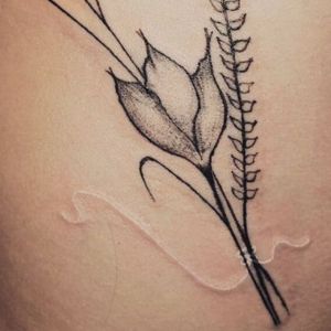 flowers white ink over black tattoo